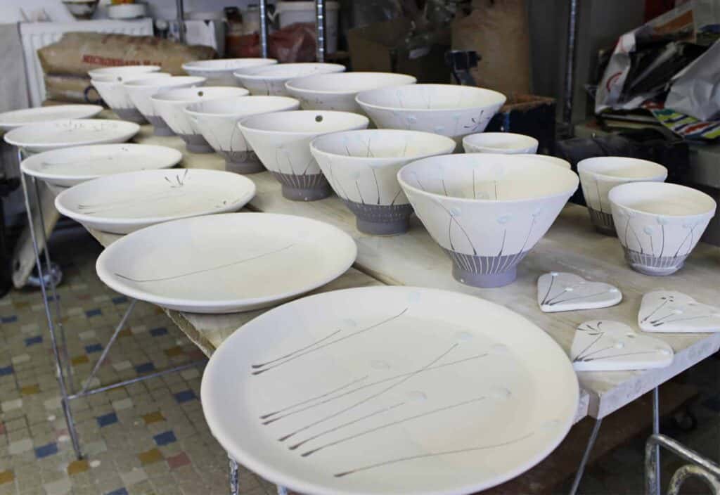 A number of plates, bowls and decorations mid production