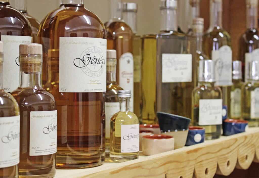 A wooden display shelf showing an array of liquor bottles