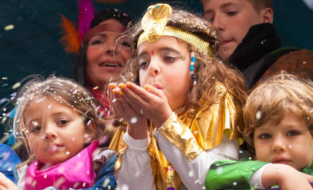 Child dressed up blowing glitter at the Bonheur des Mômes festival Le Grand Bonrand