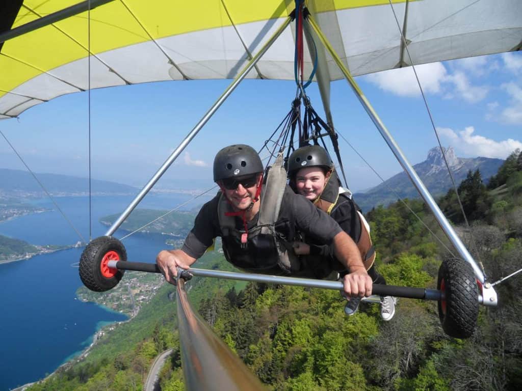 Selfie of a a tandem paraglide flight over lake annecy