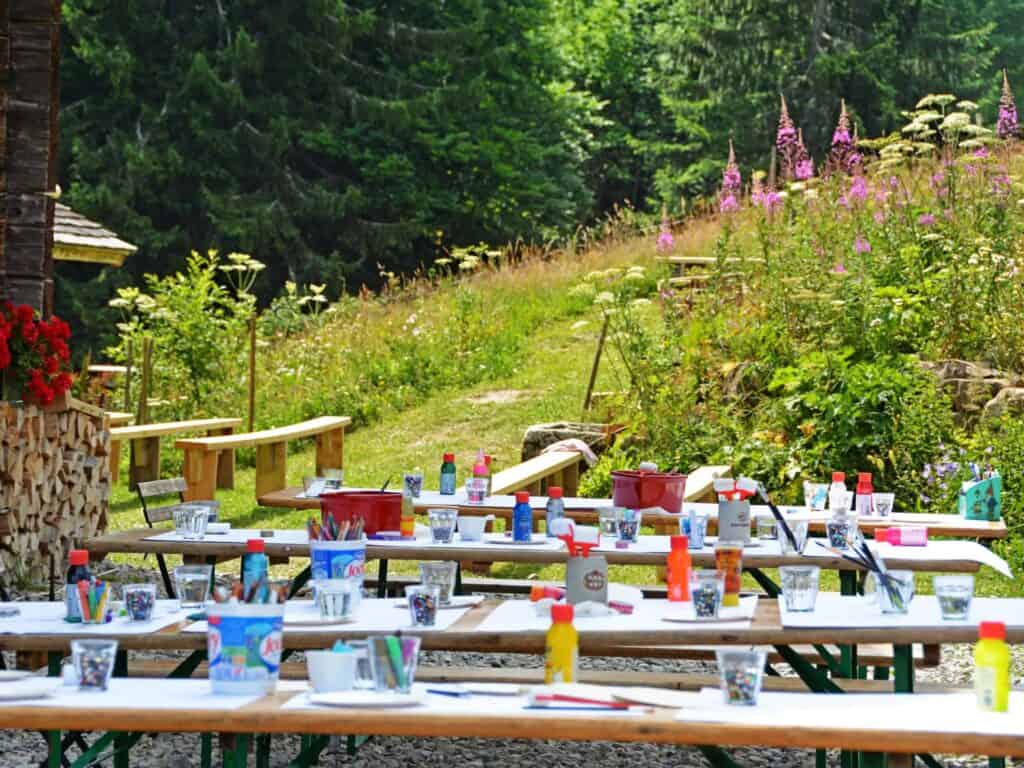 Tables set ready for children to have their lunch at a mountain farm 