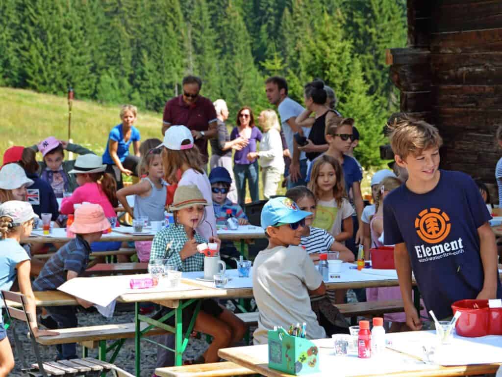Children at outdoor tables in the mountains