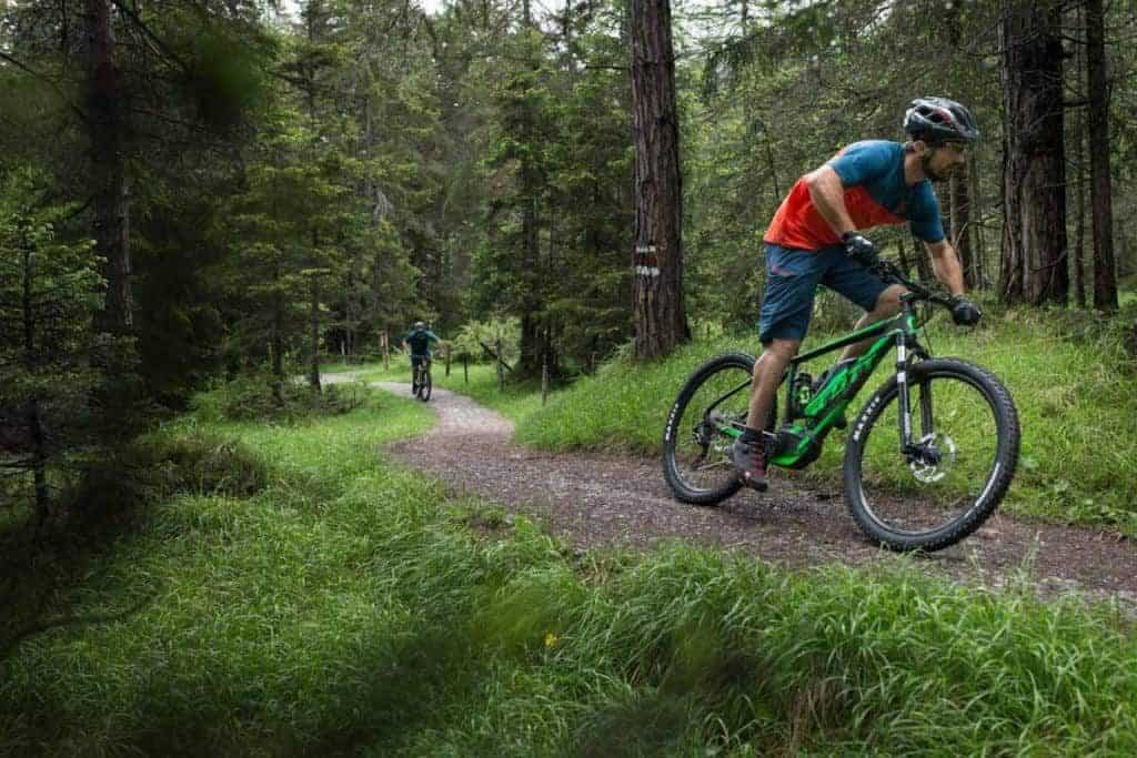 A mountain biker riding an E-bike on the La Clusaz mountain bike trails