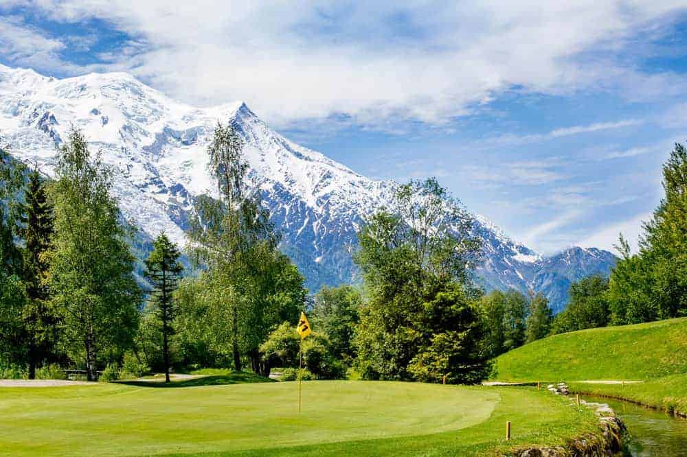 Golf in the French Alps at Evien Golf Course with a stream and mountains in the background