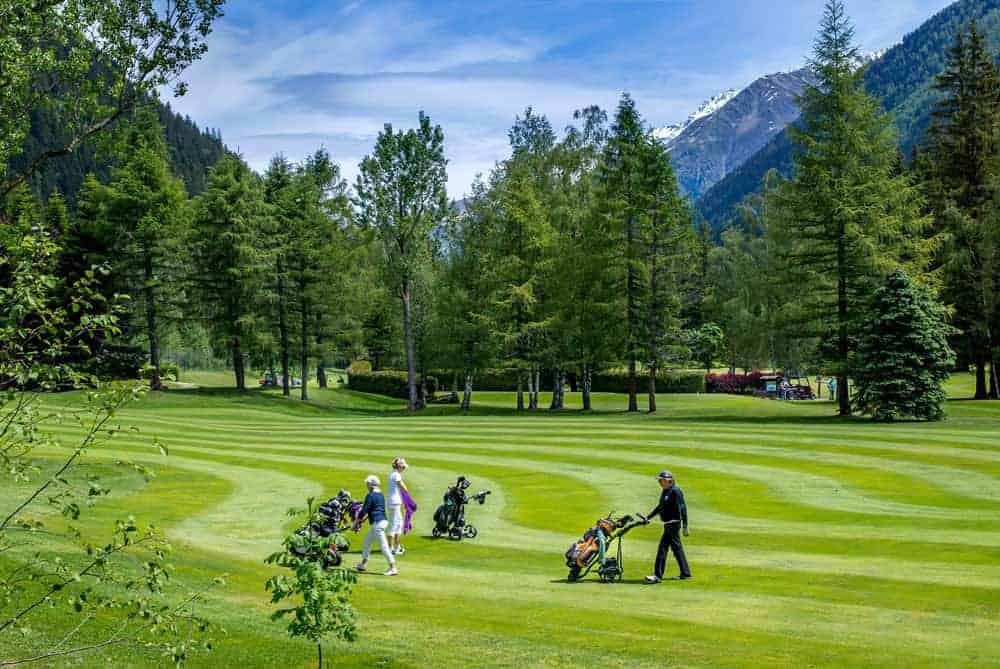 Three golfers on Lake Annecy Golf Club