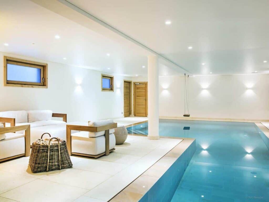 Luxury indoor pool at Chalet Explorer with a swing