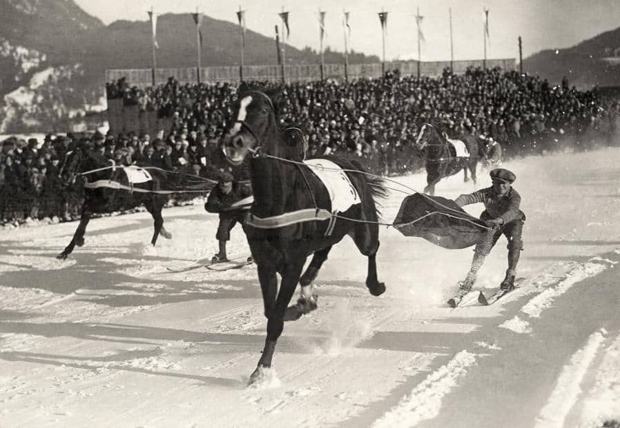 An old black and white photo of a skier being towed by a horse from the St Moritz Winter Olympics in 1928