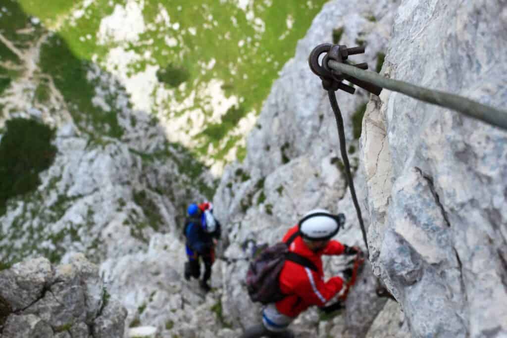 Two climbers tackling a via feratta trail in Valmorel