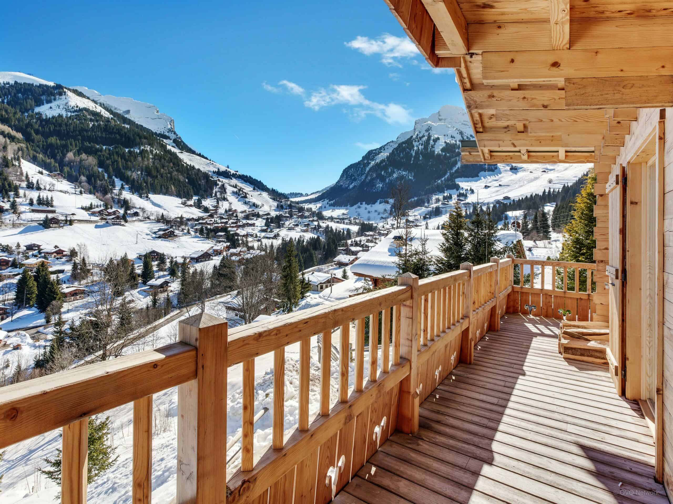 The balcony of Chalet Cristal des Neiges, with view on the valley and snowy peaks.
