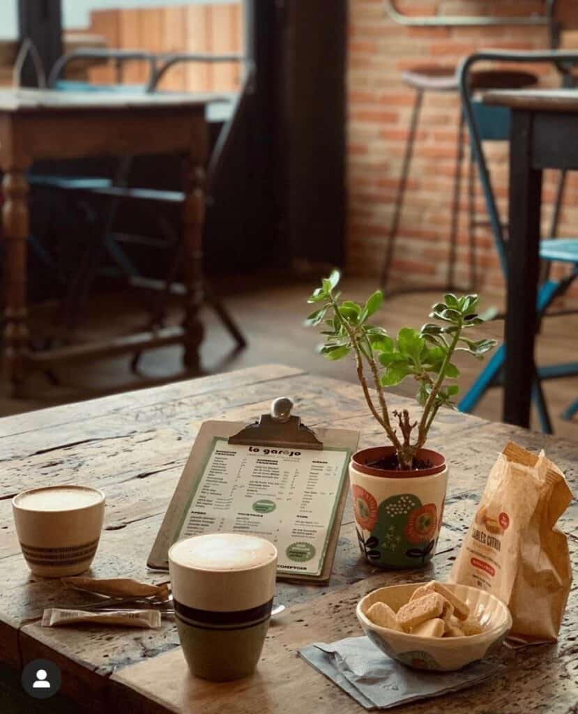 Coffees and snacks on a table with a menu