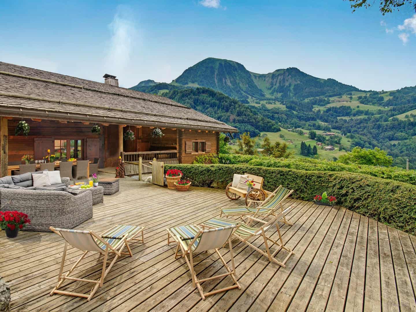 Sunbathe in the deckchairs, the lounge space or dine at the sheltered dining table at La Vieille Ferme in Manigod. 