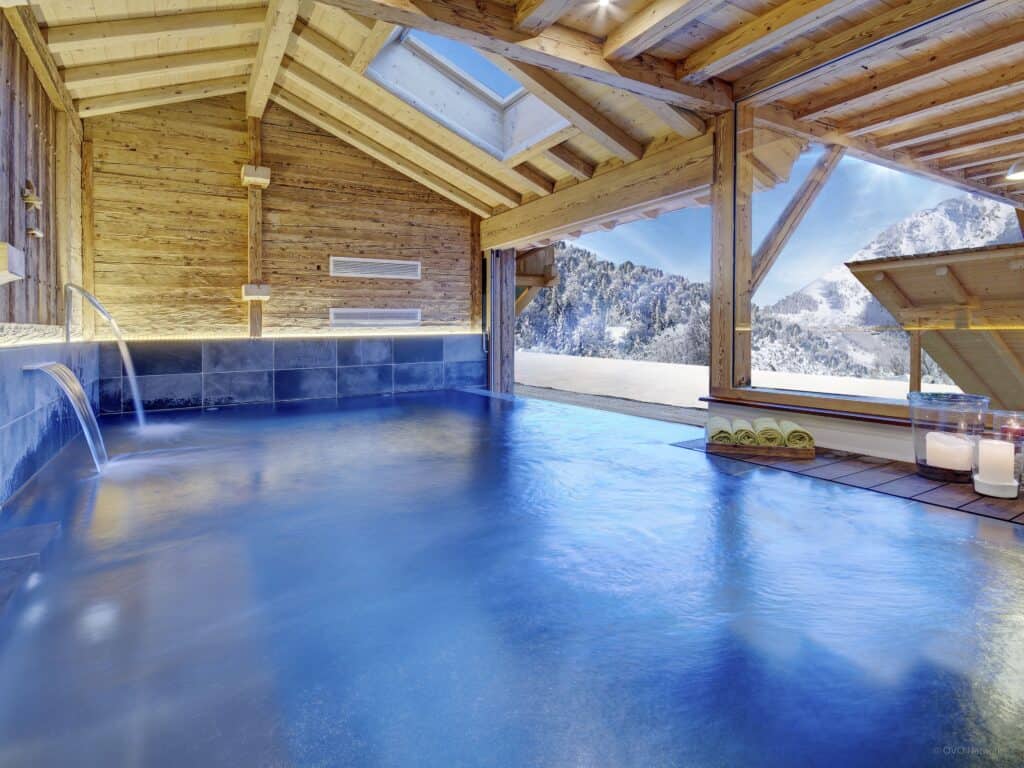 The indoor pool with snowy mountain views at Chalet Ladroit, Les Clefs.