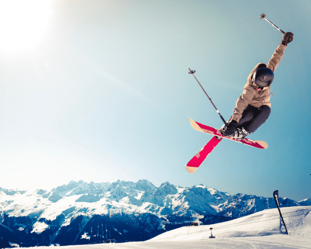 A man taking a ski jump