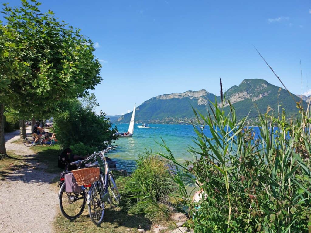 Two bikes parked on the shores of Lake Annecy