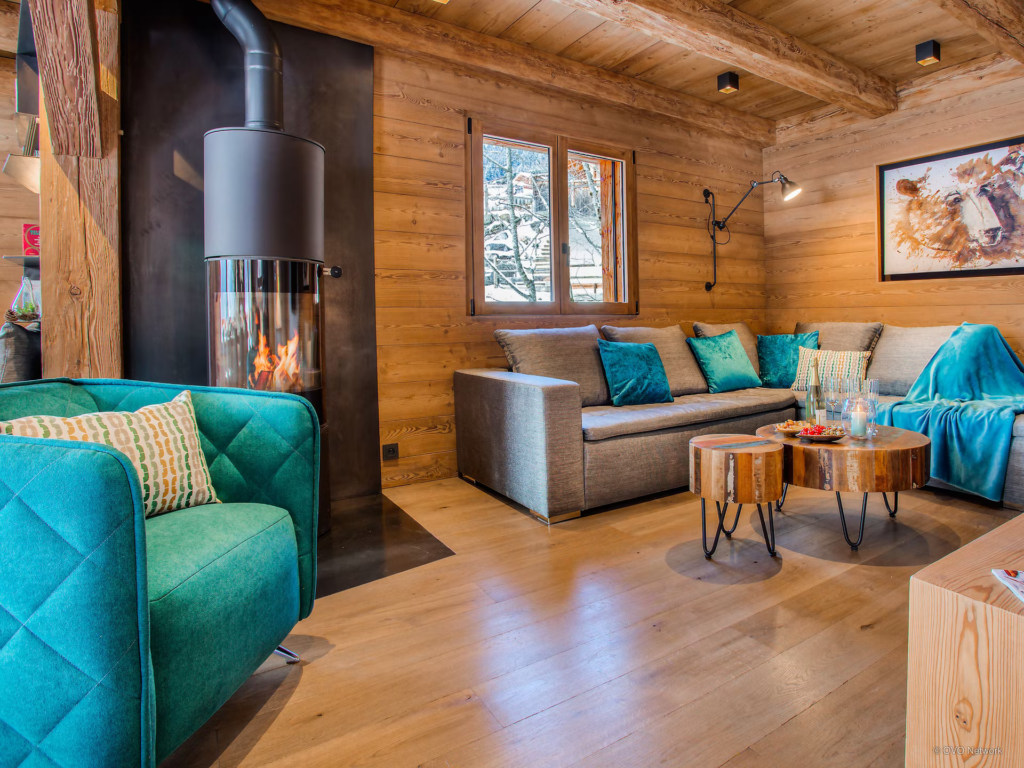 modern-living-space-hints-of-blue-cylindrical-fire-chalet-stellaone