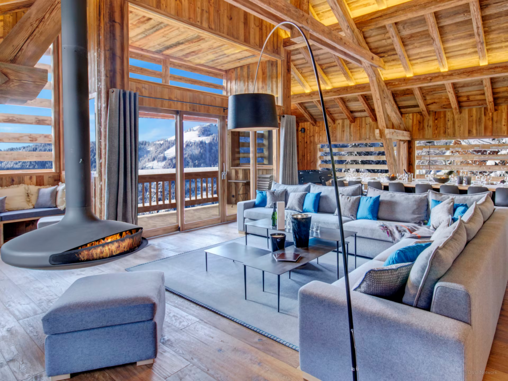 chic-sitting-room-mountain-views-cool-blue-theme-suspended-fireplace-lodge-alta-clusa