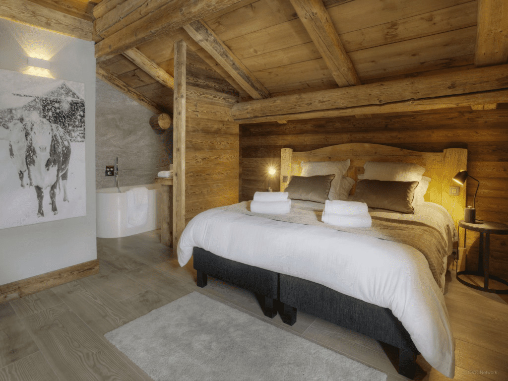 A sloped bedroom with an in build bathrooms and twinnable beds.