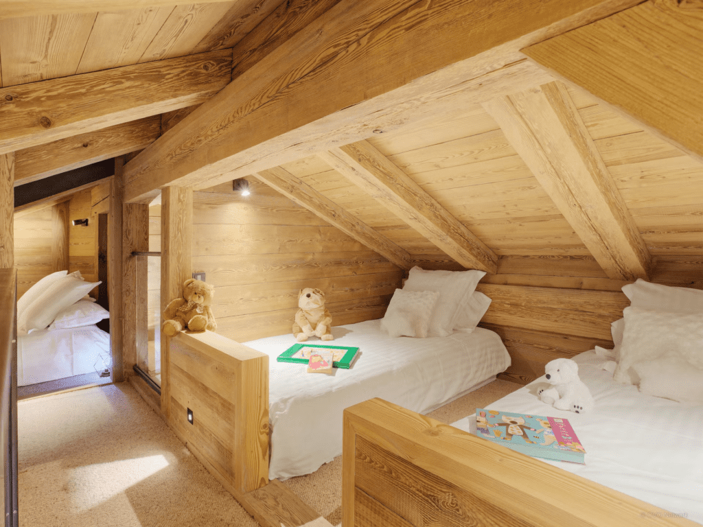 A family suite with twin beds made up with toys and games.
