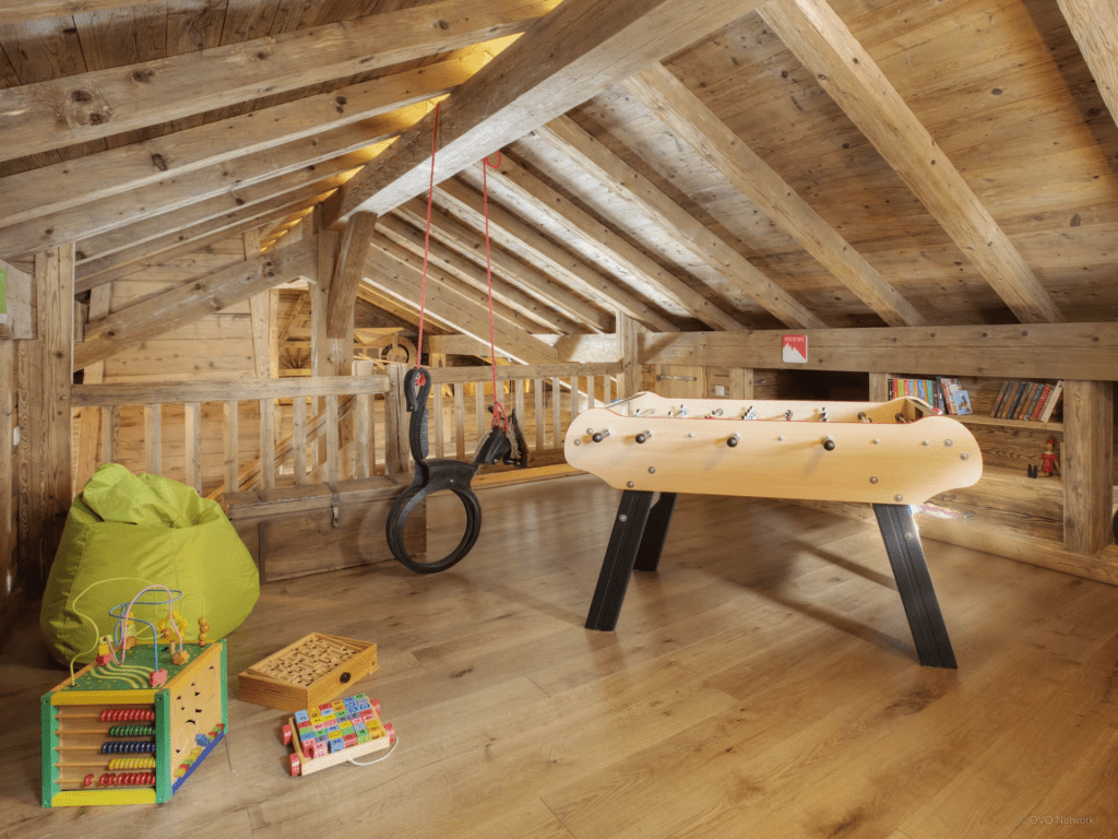 A loft style games room with table tennis, bean bags and games.