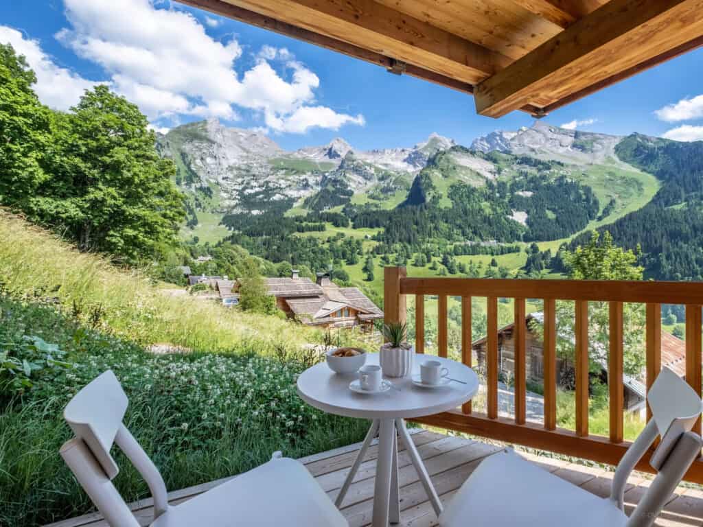 Coffee on the terrace at Chalet Bleu Infini with a mountain backdrop