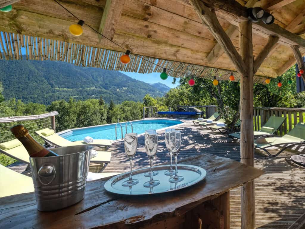 Champagne and glasses in the covered bar area at Chalet Keramis, with the pool in the background