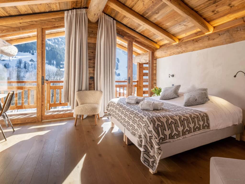 Scandinavian style - light curtains are used to  maximise the light at this bedroom in Balmaz Lodge
