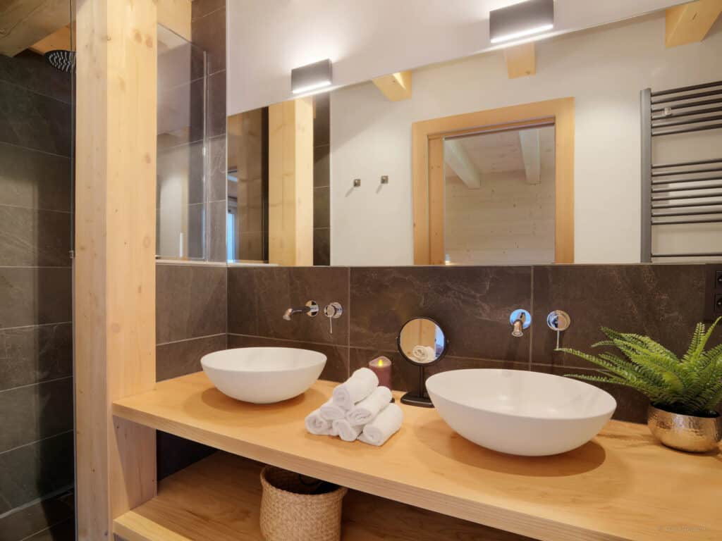 Marble and wood is mixed to create this beautiful bathroom at Chalet Belle Cour