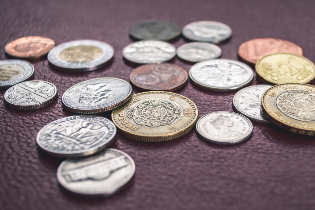Some coins on a leather surface