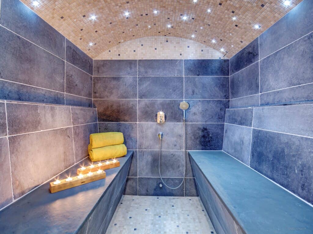 The steam room at Chalet Ladroit, Les Clefs with blue tiles and LED lighting