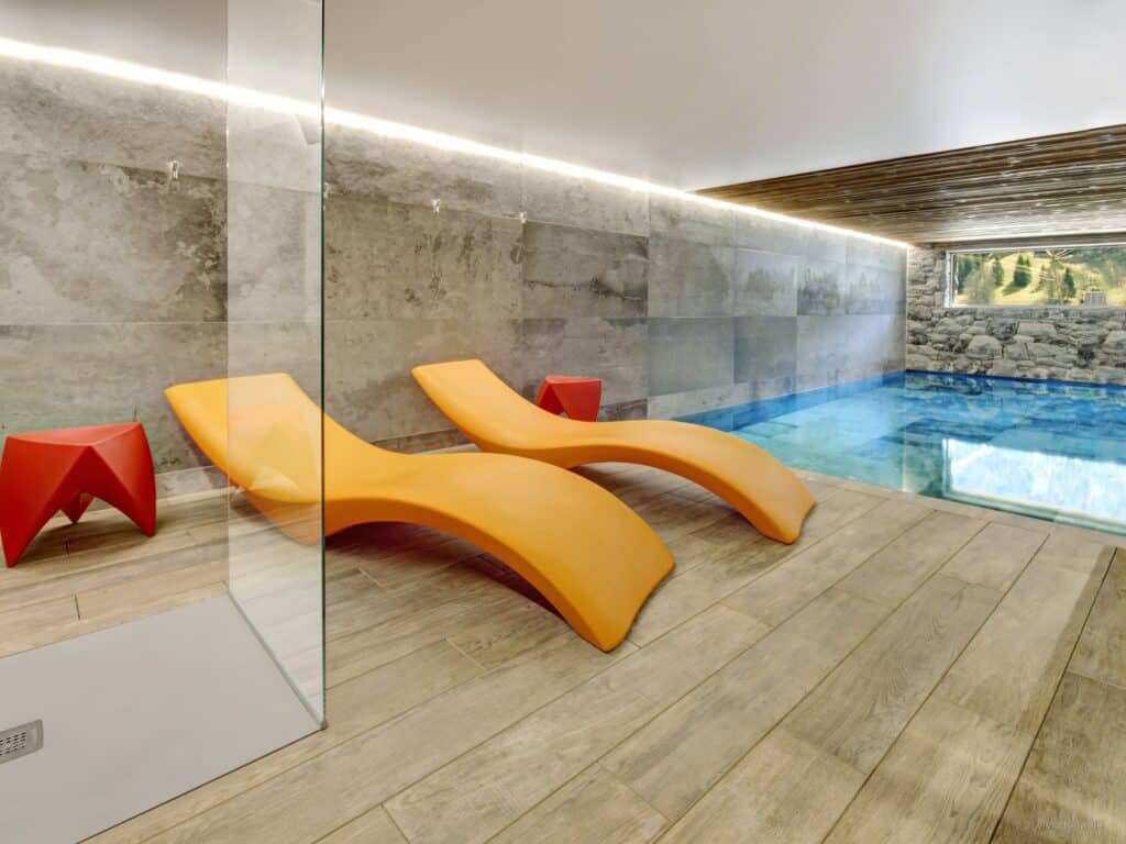 The indoor pool and modern lounge furniture at Chocoon Lodge, La Clusaz