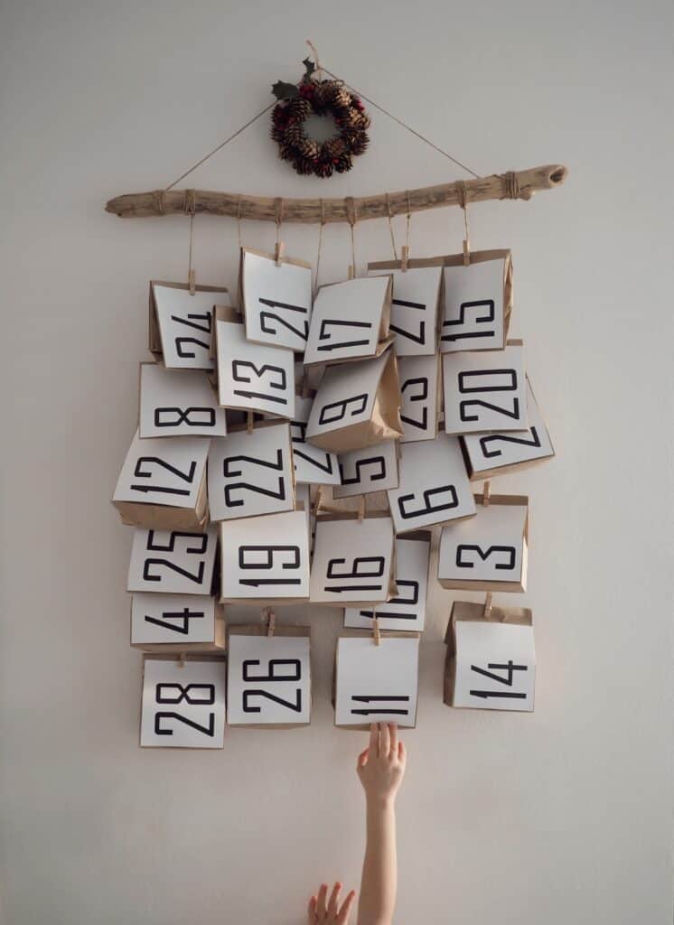 A child reaches for a number on this natural advent calendar
