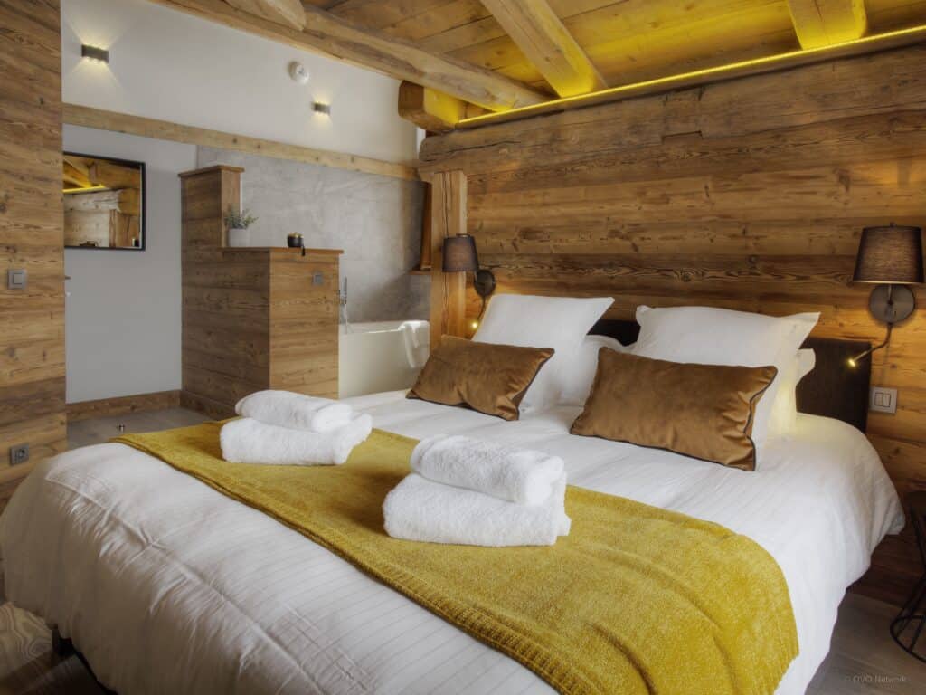 One of the bedrooms at Chalet Goville with double bed and gold furnishings