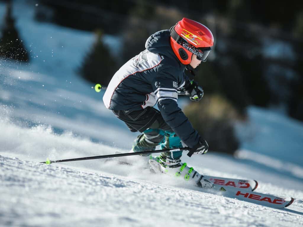 A child enjoys skiing down a mountain