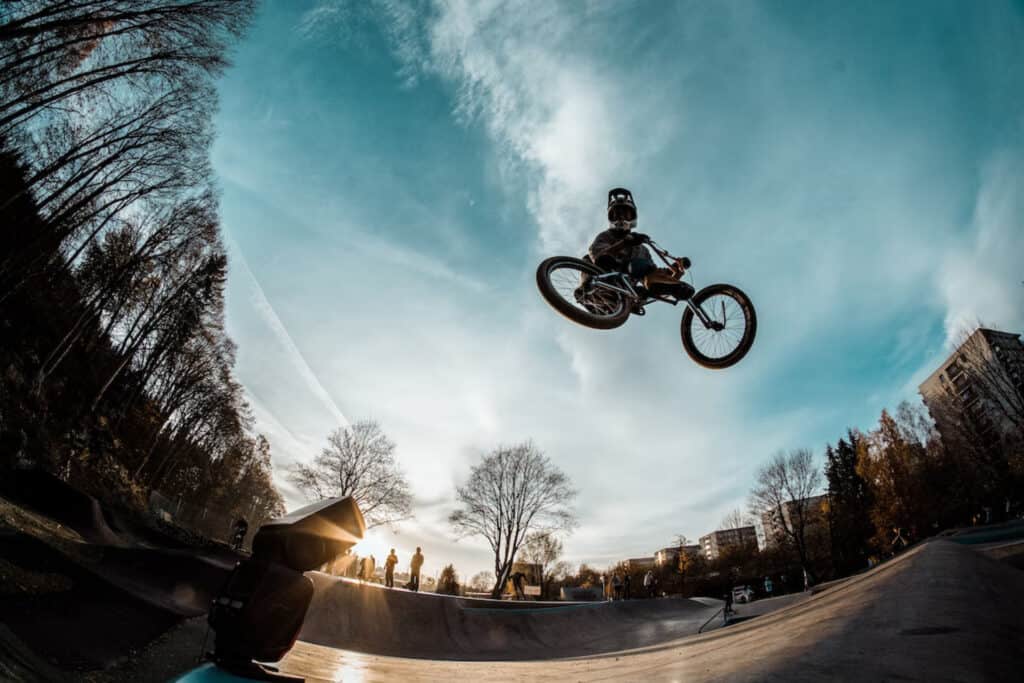 A rider leaps in to the air on a BMX bike