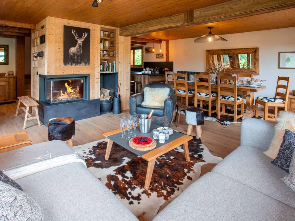 Living space Chalet Bonnevie with deer art above log burning fireplace