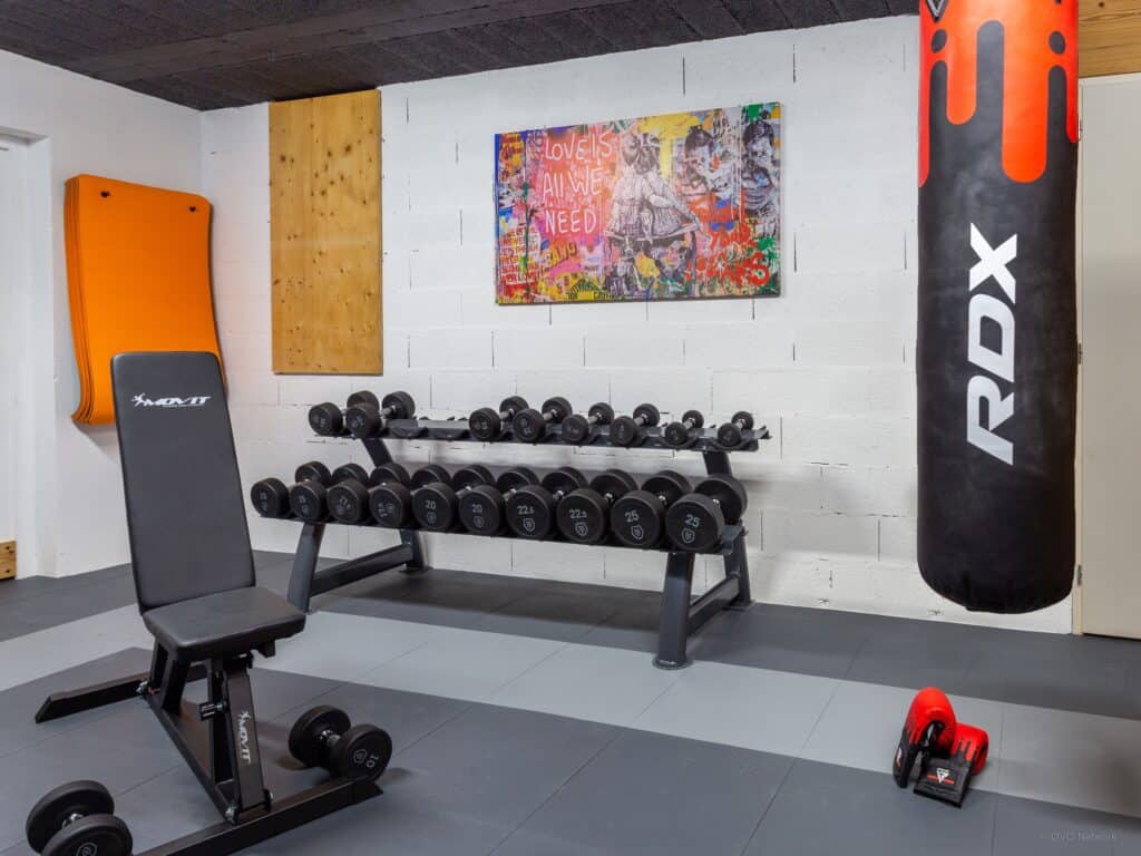Home gym with weight bench and punch bag