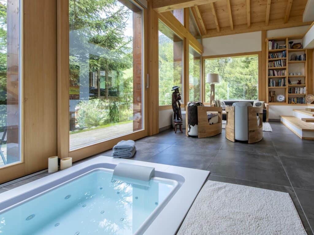 Indoor hot tub and living area at Chalet Cinq Moutons