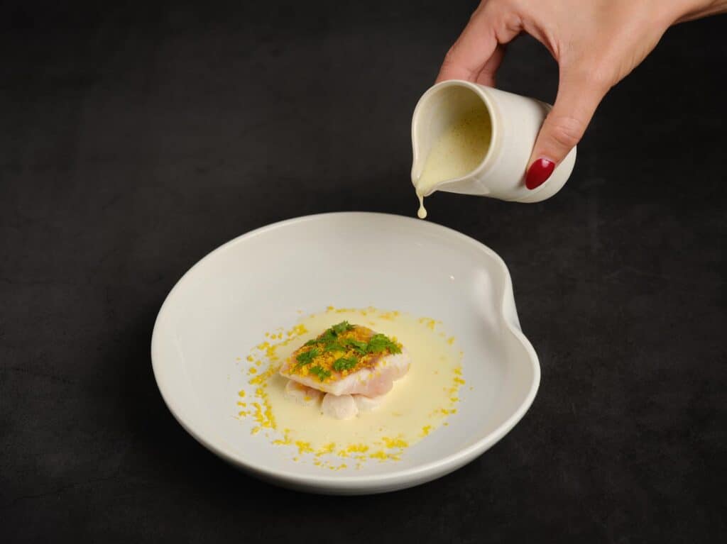 A simple dish of fish and sauce served at the Table de Yoann Conte. 