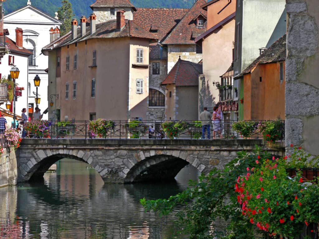 A bridge in the old town of Annecy is reflected in the canal