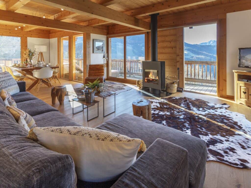 Living/dining room with mountain views and a fireplace with large comfortable sofa