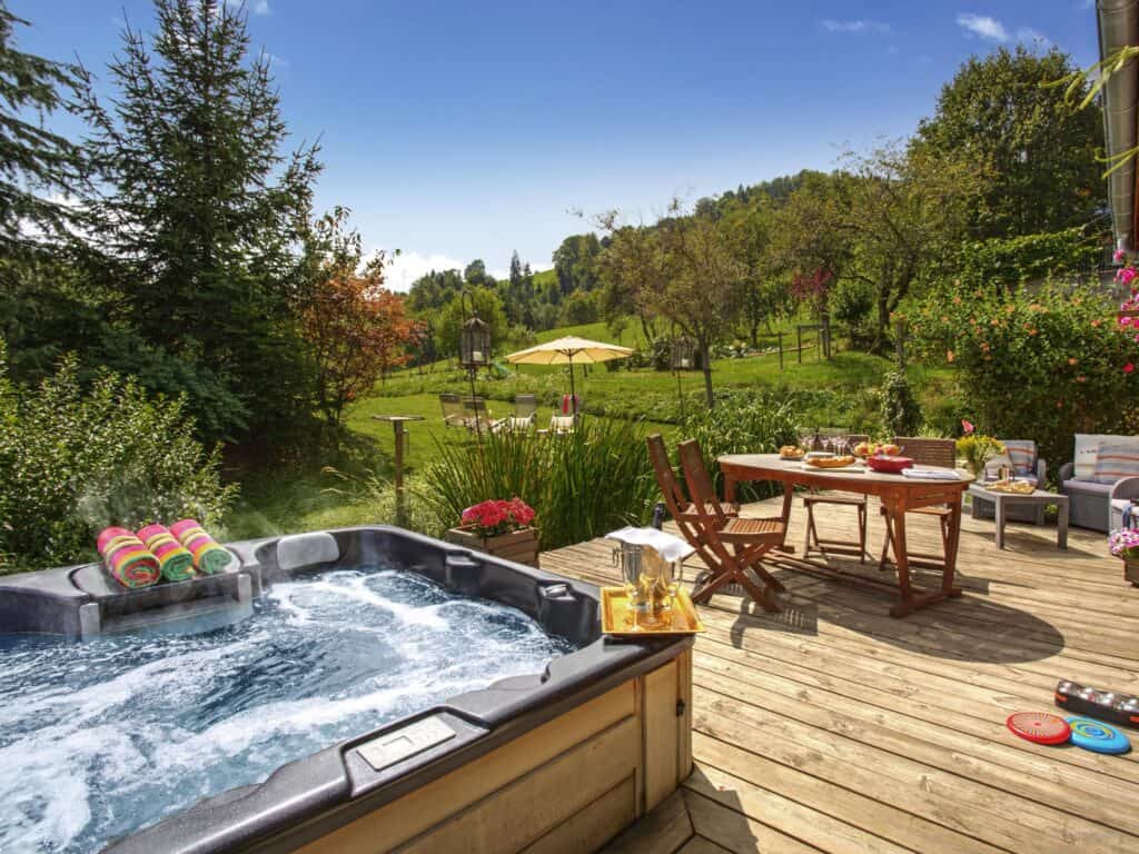 Chalet Les Roses des Alpes decked terrace with hot tub and gardens