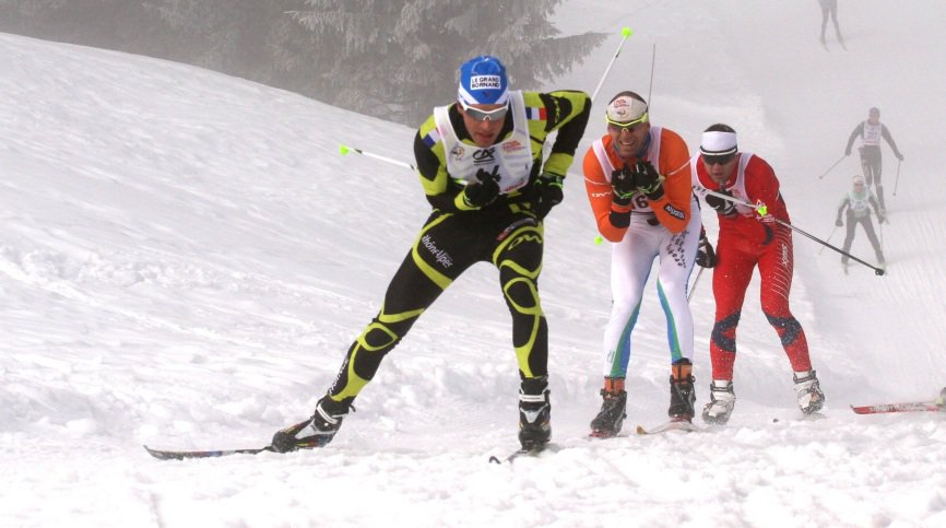 Participants in a cross-country ski marathon at Glières tackle a hill