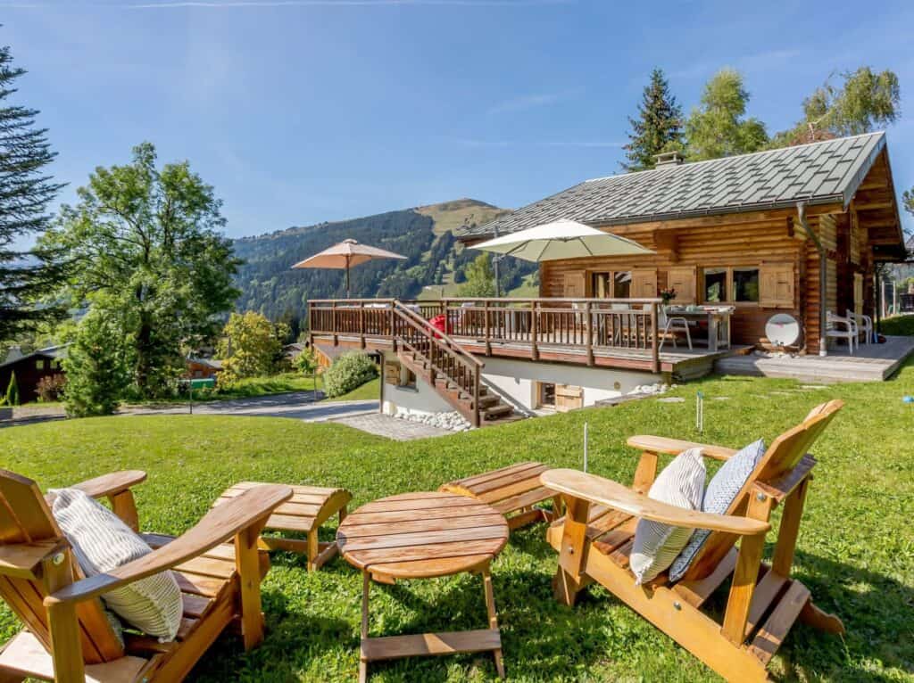 A sunny seating area in the garden, looking at Chalet Joux Verte
