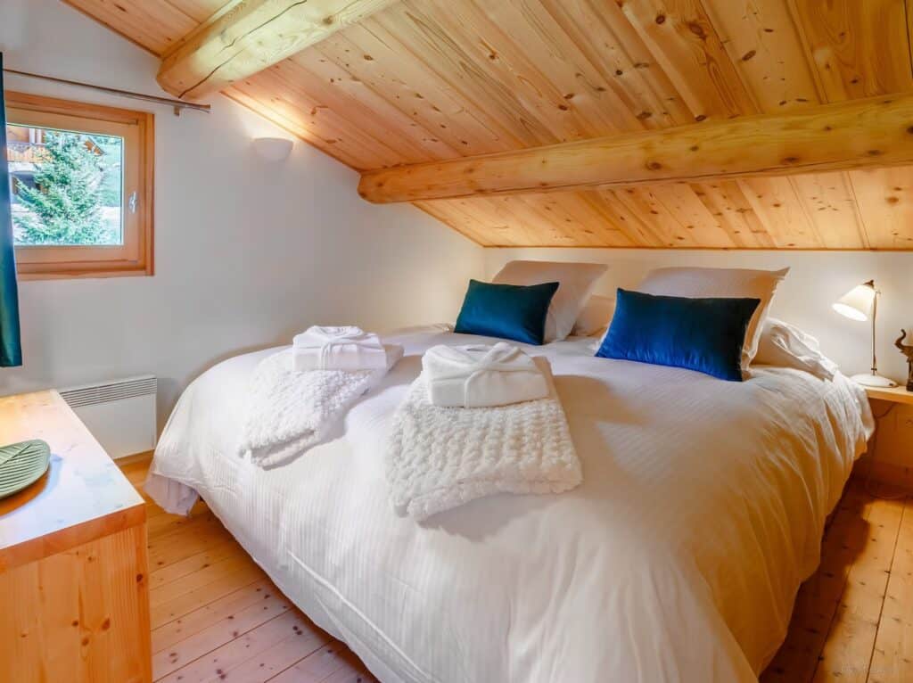 The comfortable double bed in the master bedroom under the eaves