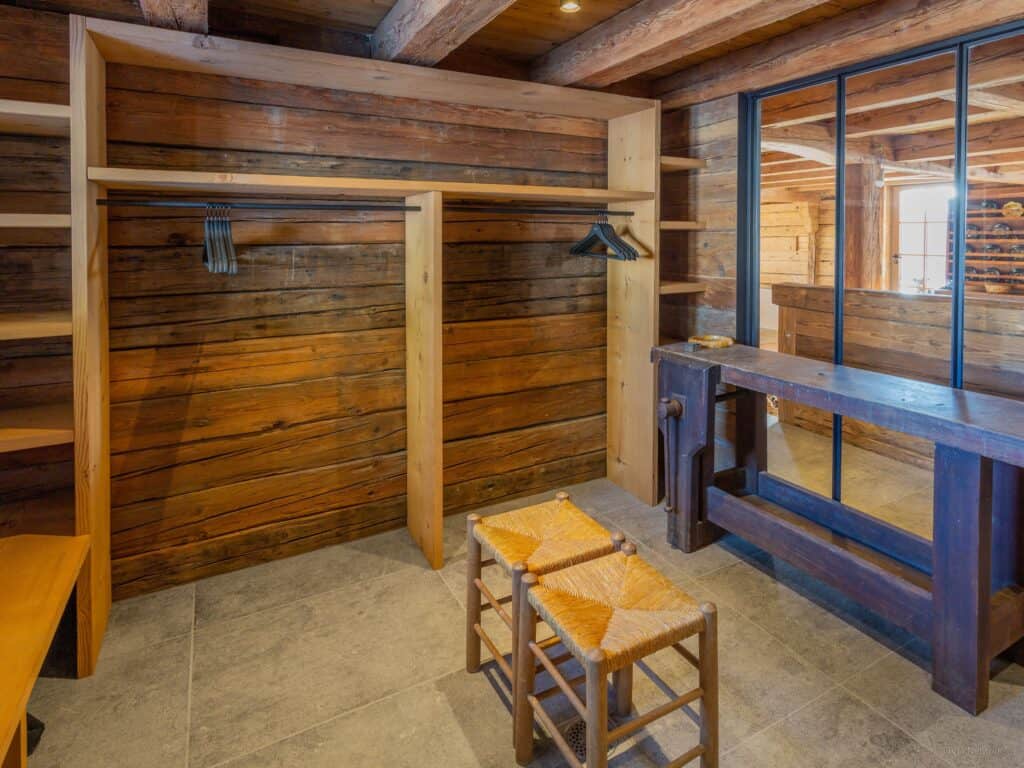 The ski room at Chalet Sisar, with shelves, hanging space and benches