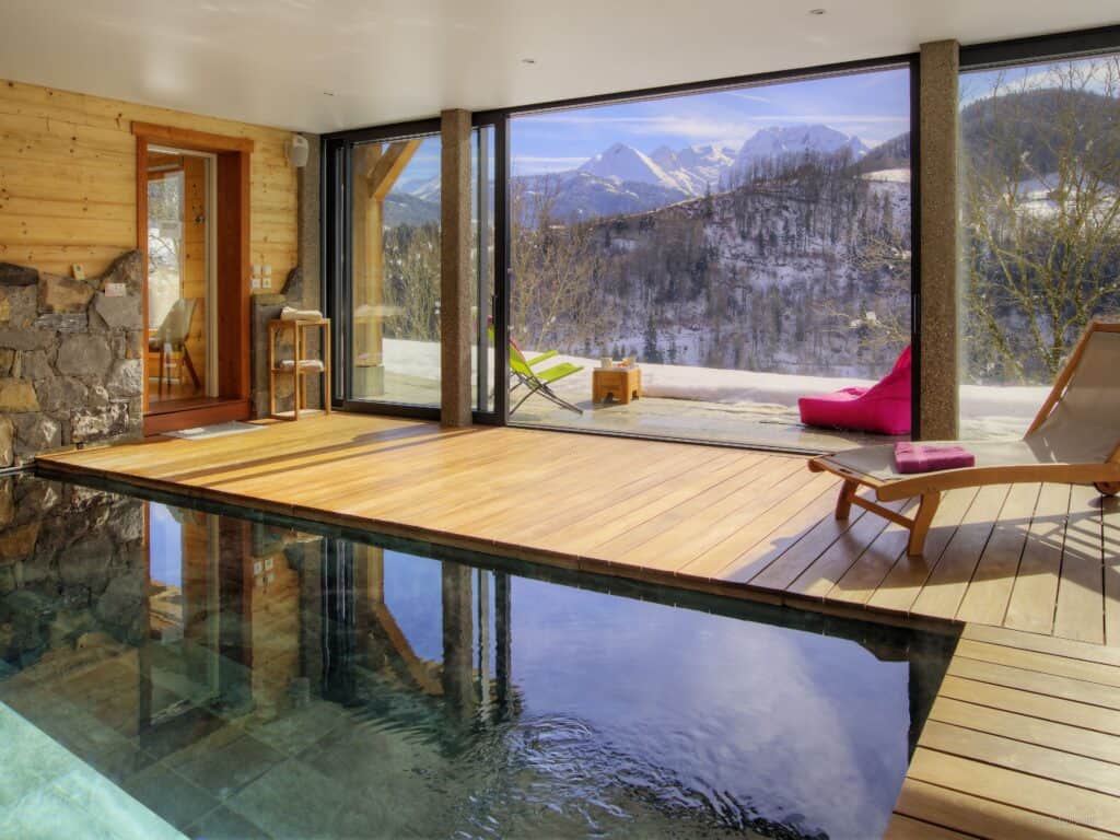 Indoor swimming pool overlooking snowy mountains