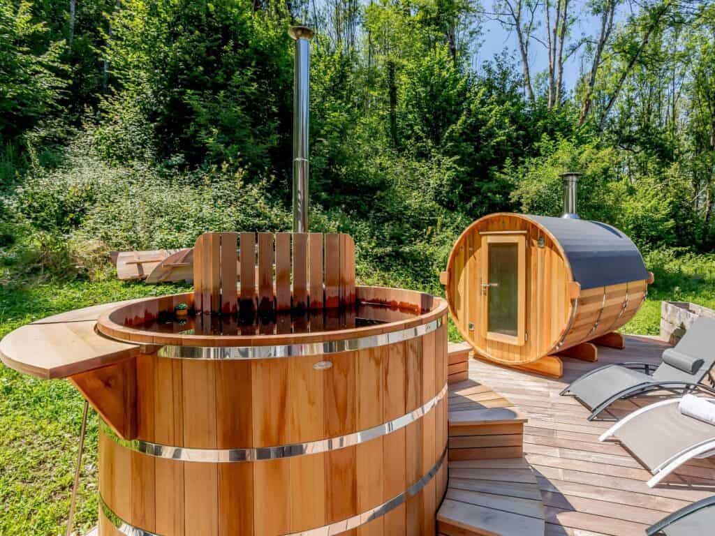 An outdoor barrel sauna and hot tub