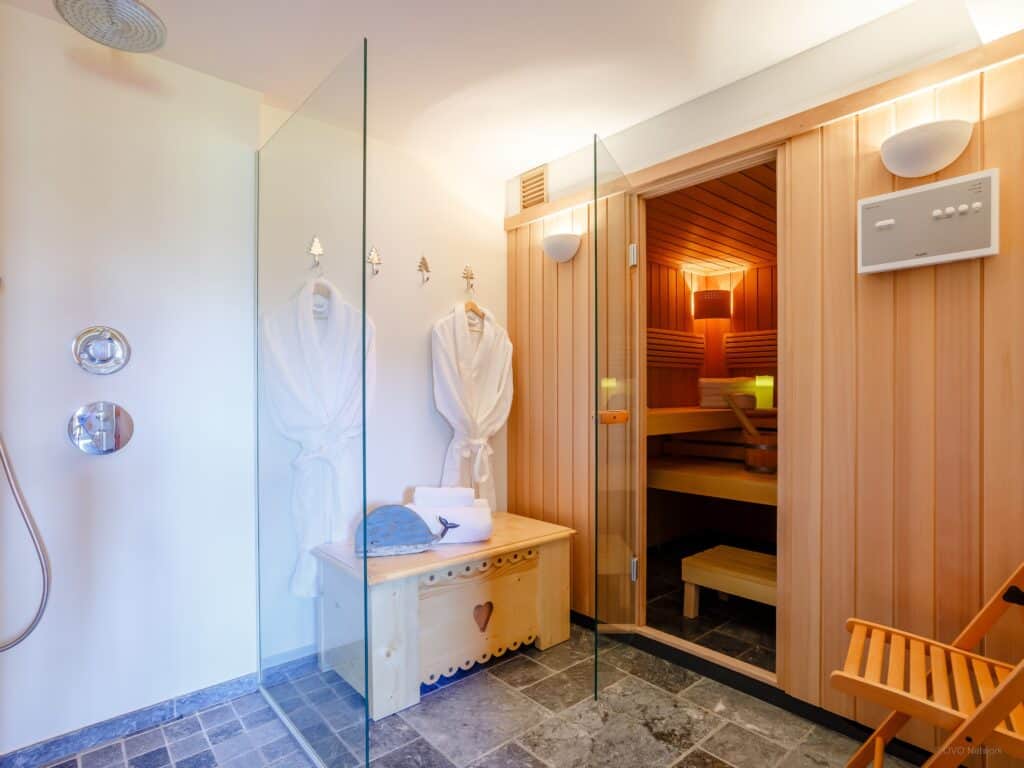 Indoor sauna and shower with bath robes at Chalet Joux Verte