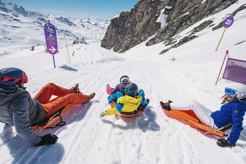 Several people on sledges at the start of a run in the 3 Valleys area. 