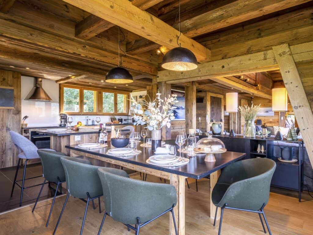 Dining room with dark green chairs at Chalet Minnetonka